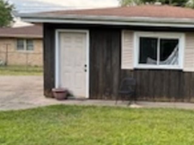 view of outbuilding with a yard