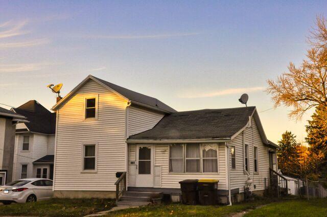 traditional home with a front lawn and entry steps