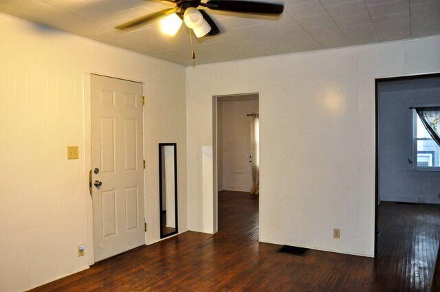 spare room featuring wood finished floors and a ceiling fan
