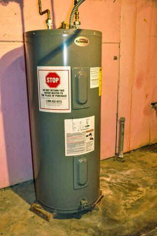 utility room featuring electric water heater