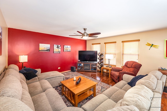 living room featuring dark hardwood / wood-style flooring and ceiling fan