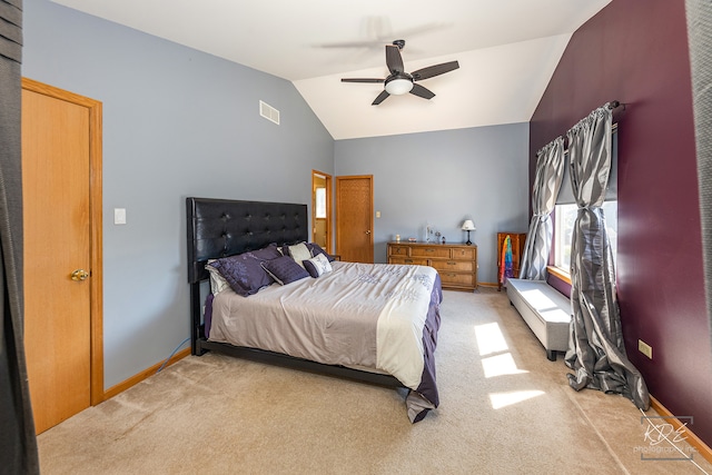 carpeted bedroom with ceiling fan and vaulted ceiling