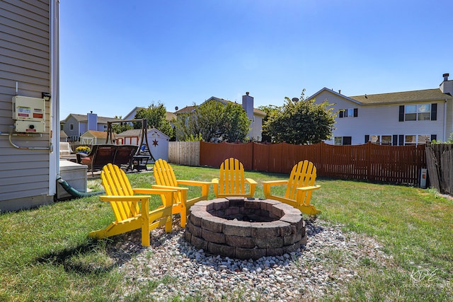 view of yard featuring an outdoor fire pit