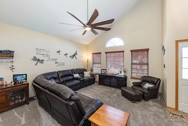 carpeted living room with ceiling fan and high vaulted ceiling