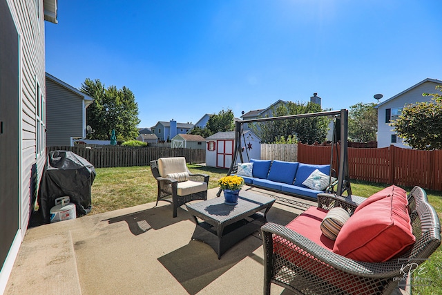 view of patio / terrace with an outdoor living space and a storage shed