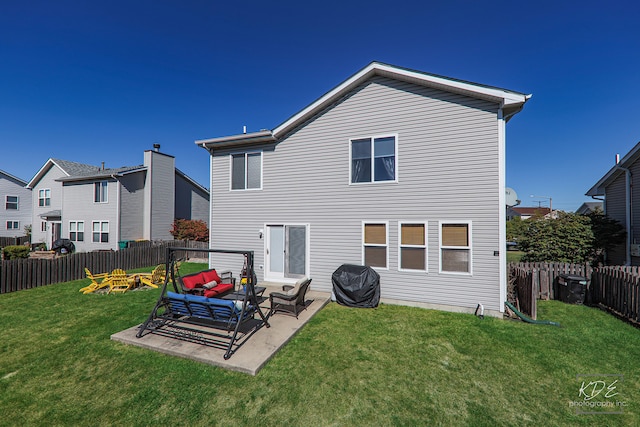 back of property featuring a patio area and a yard