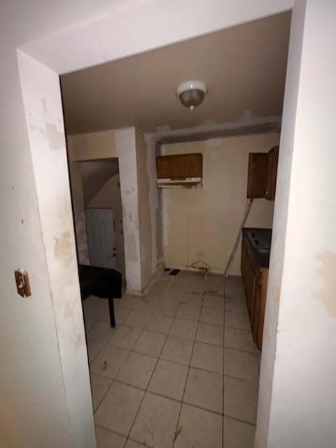 hallway with light tile patterned floors