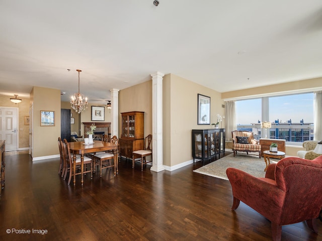 dining room featuring a chandelier, decorative columns, and dark hardwood / wood-style flooring