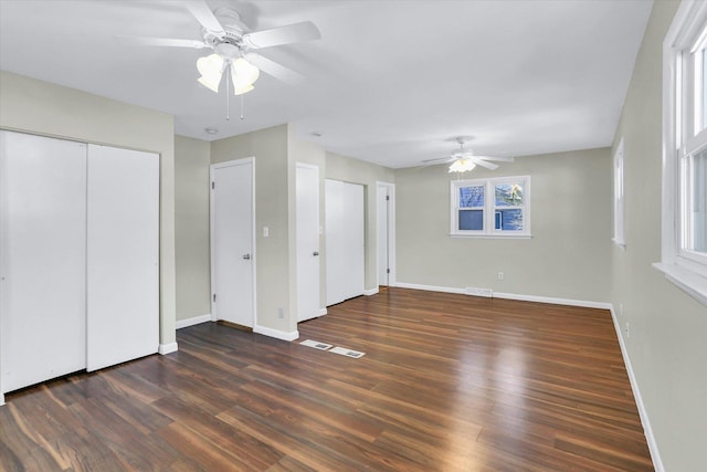 unfurnished bedroom featuring dark hardwood / wood-style flooring and ceiling fan