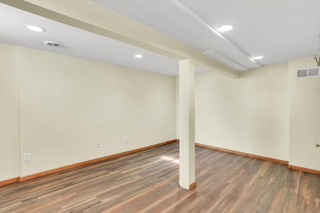 basement with dark hardwood / wood-style floors