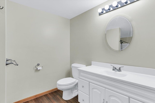 bathroom featuring hardwood / wood-style flooring, vanity, and toilet