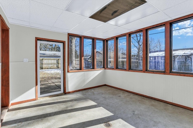 unfurnished sunroom with a drop ceiling