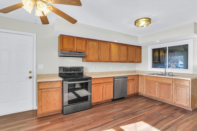 kitchen with stainless steel appliances, sink, and dark hardwood / wood-style floors