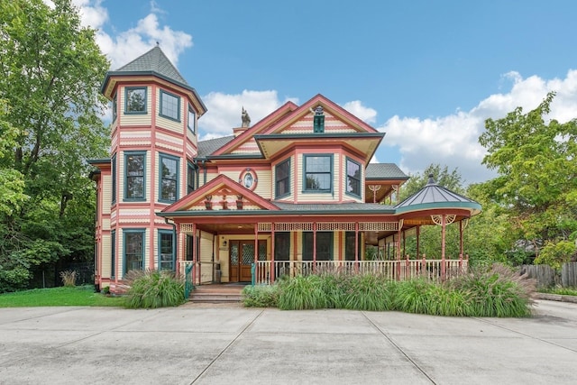 victorian-style house featuring a porch