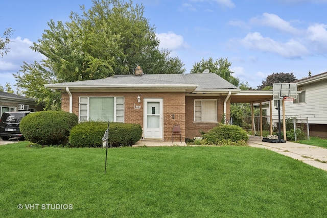 view of front of property with a carport and a front yard