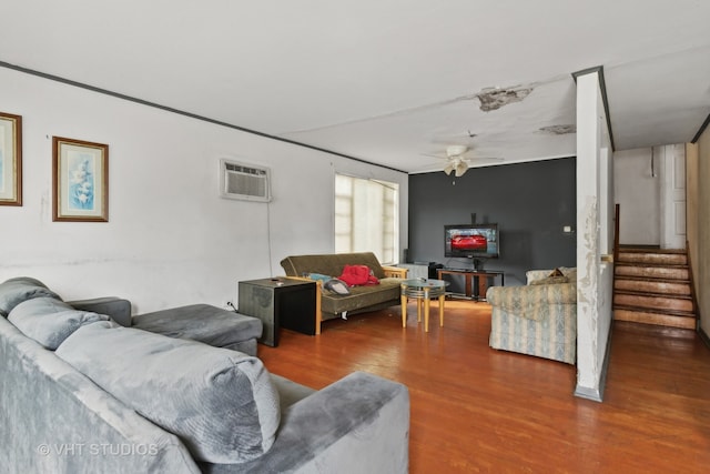 living room with hardwood / wood-style floors, an AC wall unit, and ceiling fan