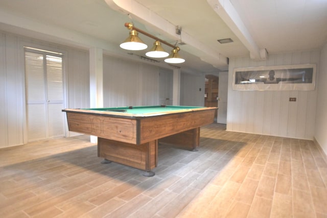 recreation room with hardwood / wood-style floors, beam ceiling, and wood walls