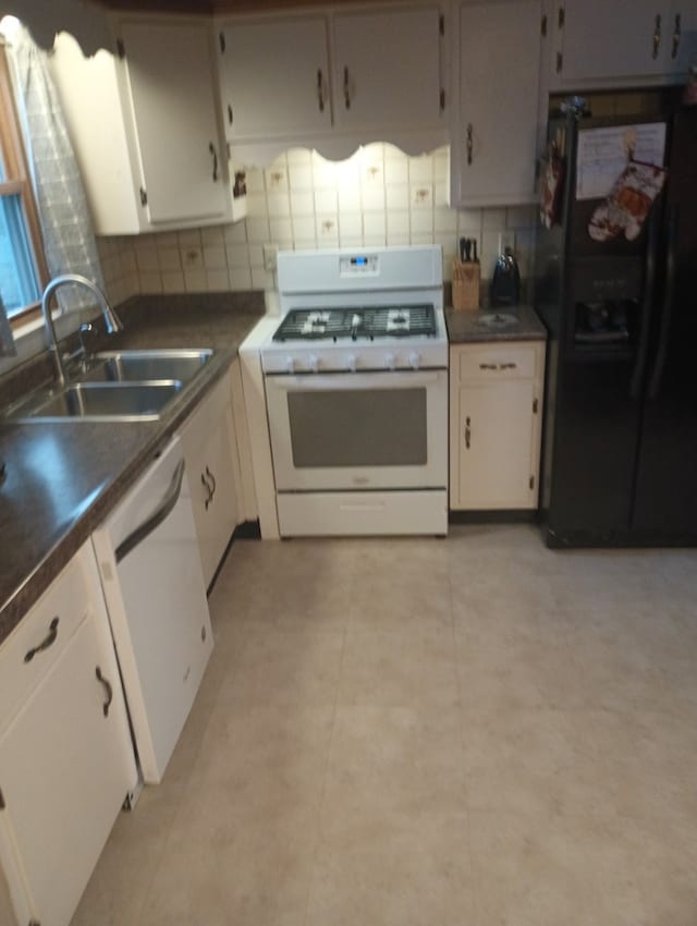 kitchen featuring tasteful backsplash, sink, white cabinets, and white appliances