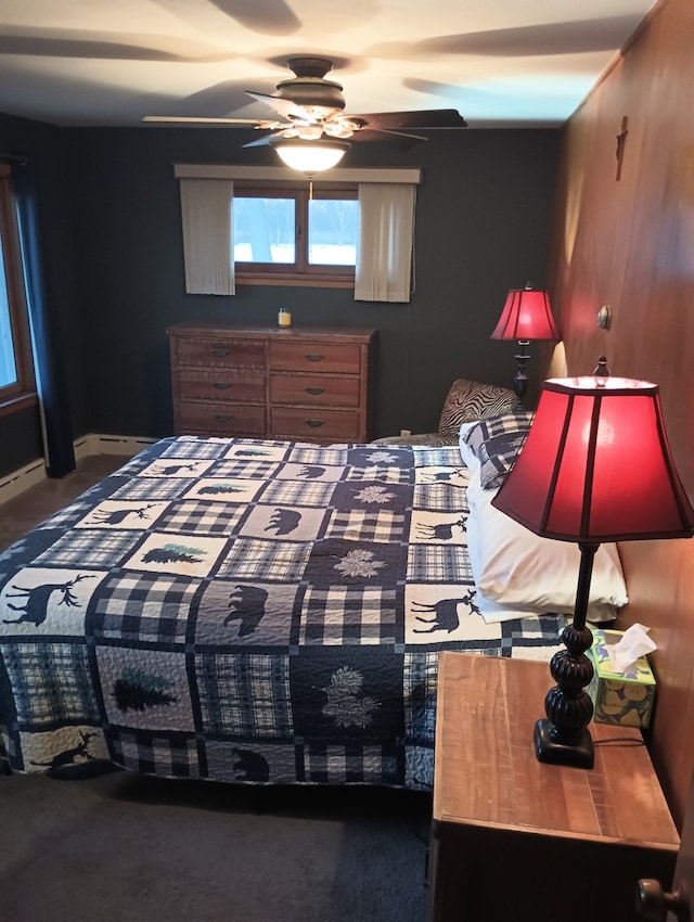 carpeted bedroom featuring ceiling fan and wood walls