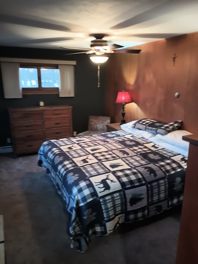 carpeted bedroom featuring ceiling fan and a baseboard radiator