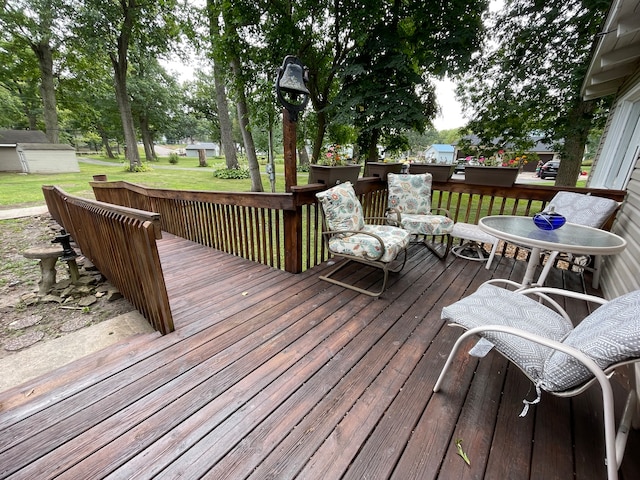 wooden deck with a lawn