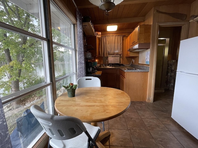 kitchen featuring plenty of natural light, white fridge, wooden ceiling, and sink