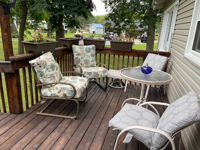 wooden deck with a lawn