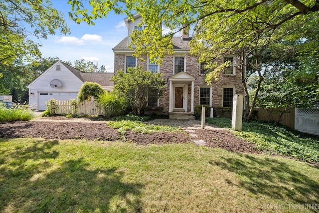 view of front of property featuring a garage and a front lawn