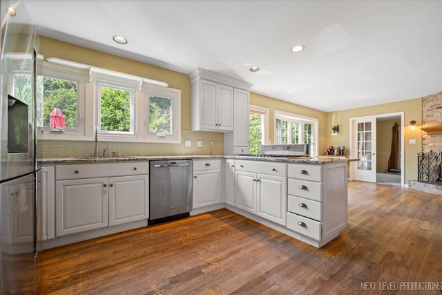 kitchen featuring white cabinets, hardwood / wood-style floors, and stainless steel appliances