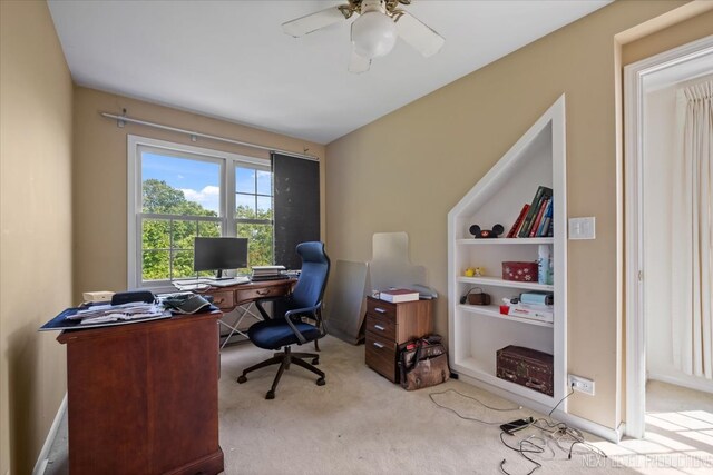 carpeted home office featuring ceiling fan