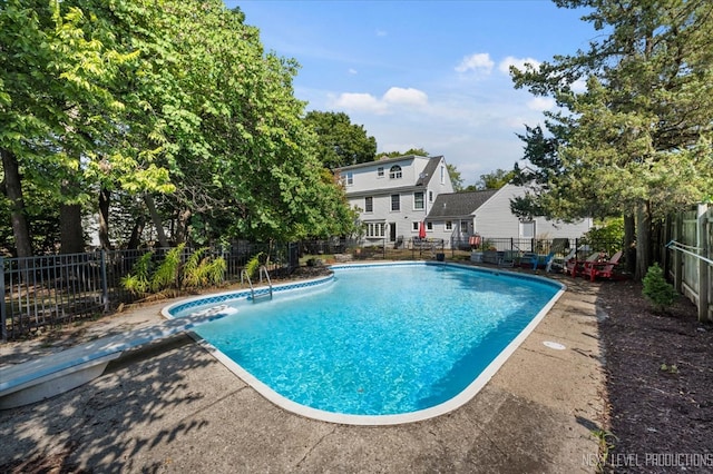 view of swimming pool with a patio