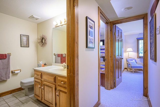 bathroom with visible vents, connected bathroom, baseboards, toilet, and vanity