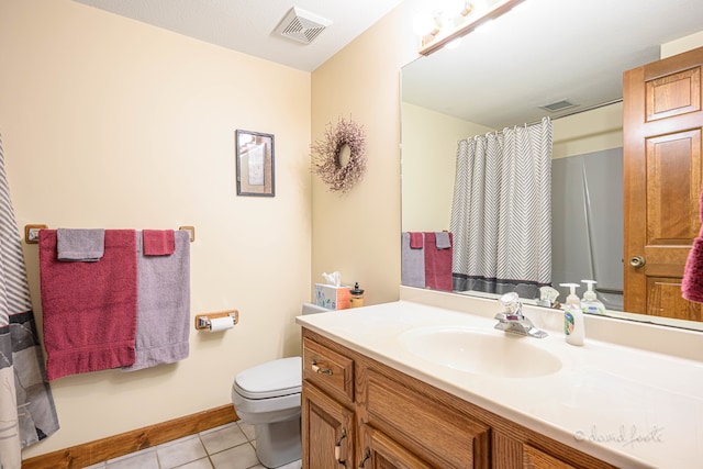 bathroom with vanity, toilet, and tile patterned floors