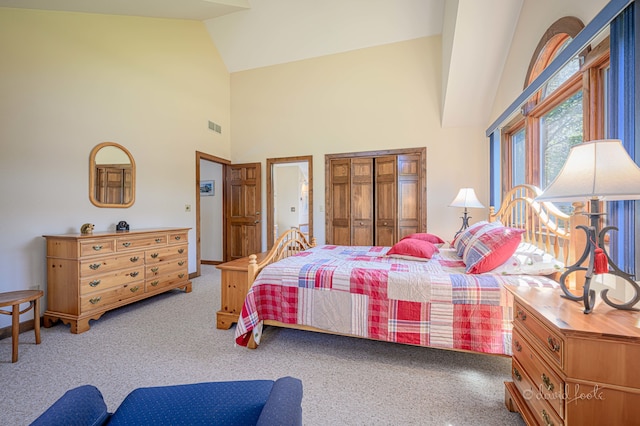 bedroom featuring high vaulted ceiling and light colored carpet