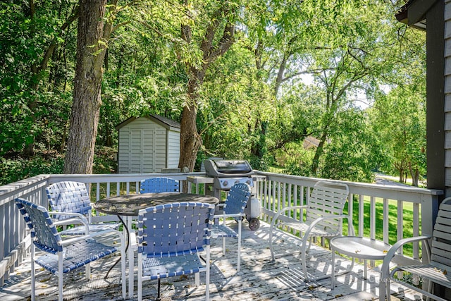 deck with a grill and a storage unit