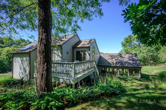 view of side of home featuring a wooden deck