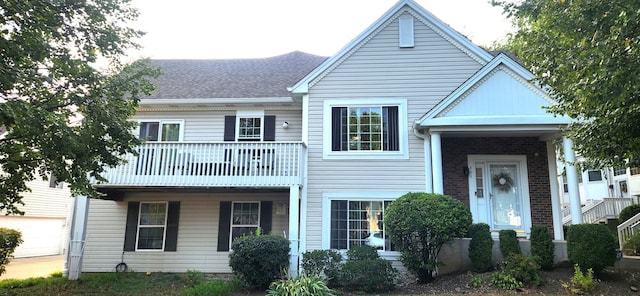 view of front of property featuring a garage and a balcony