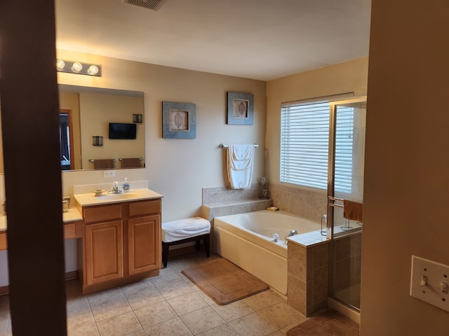 bathroom featuring shower with separate bathtub, vanity, and tile patterned flooring