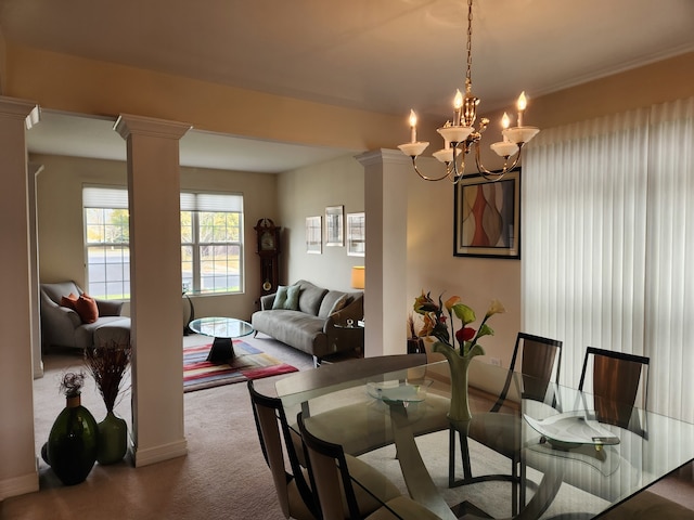 dining room featuring a chandelier, crown molding, ornate columns, and carpet floors