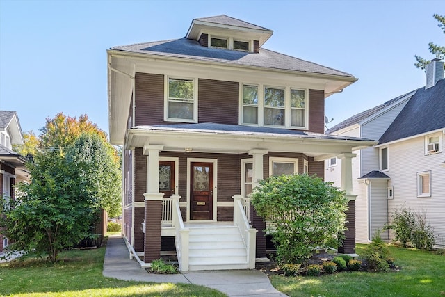 view of front facade featuring a front lawn and covered porch