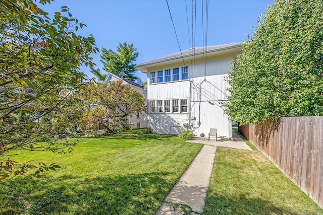 rear view of house featuring a yard