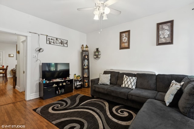 living room featuring hardwood / wood-style flooring and ceiling fan