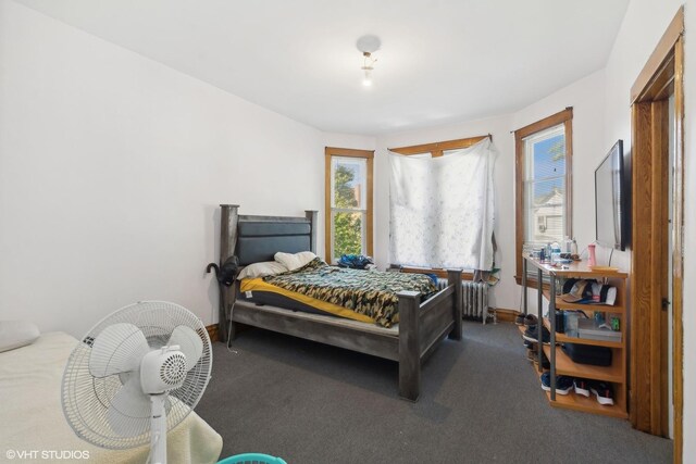 bedroom featuring radiator and carpet floors