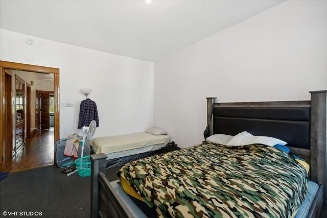 bedroom with dark wood-type flooring