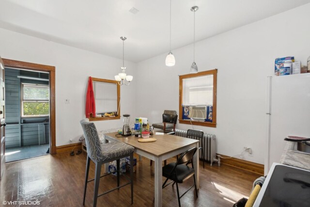 dining room featuring radiator, dark hardwood / wood-style flooring, a chandelier, and cooling unit