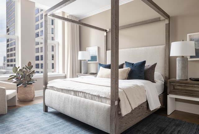 bedroom featuring dark wood-type flooring and ornamental molding