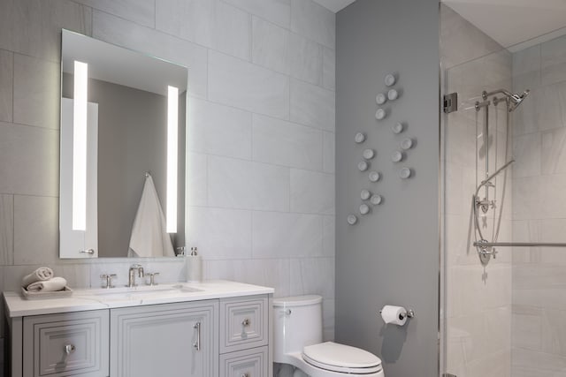 bathroom featuring a tile shower, vanity, tile walls, toilet, and backsplash