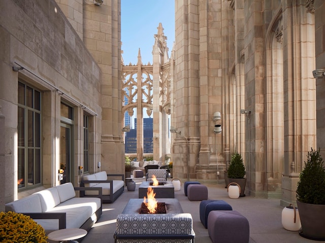 view of patio / terrace with an outdoor living space with a fire pit