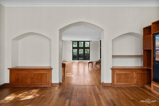 interior space featuring crown molding and dark hardwood / wood-style flooring