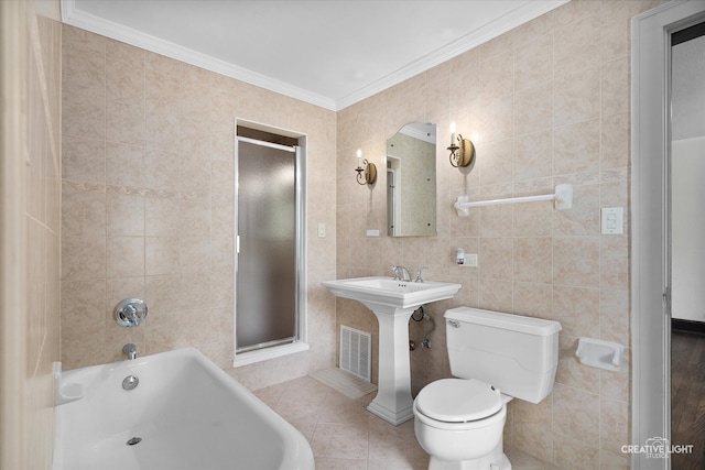 bathroom with tile walls, tile patterned flooring, toilet, and plus walk in shower